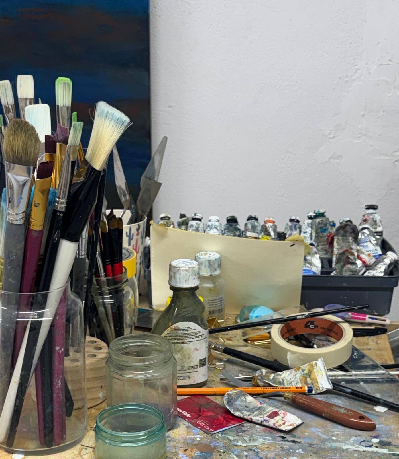 Marie Kelly's studio with paint brushes, oil paints and artist tools