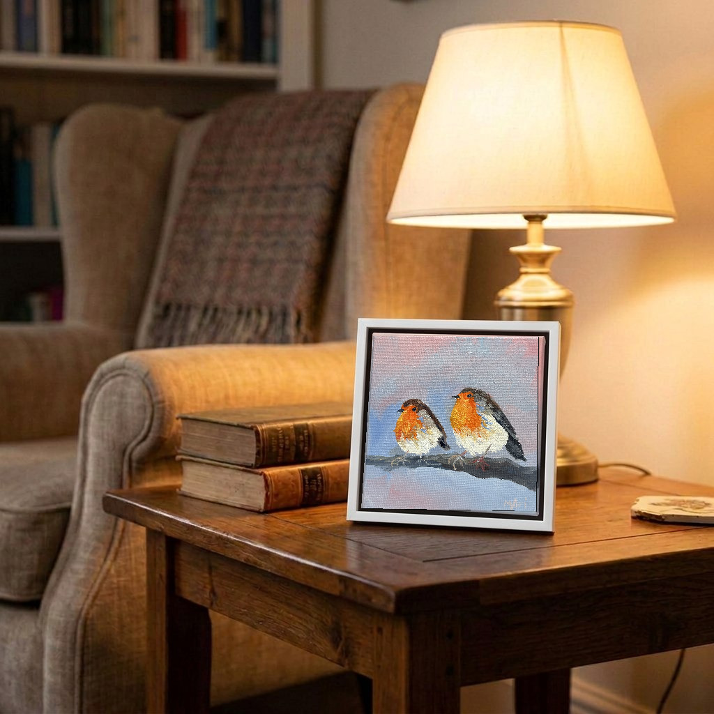 In situ — sitting on a side table, shown in a slim white frame, approximately 15 × 15 cm framed