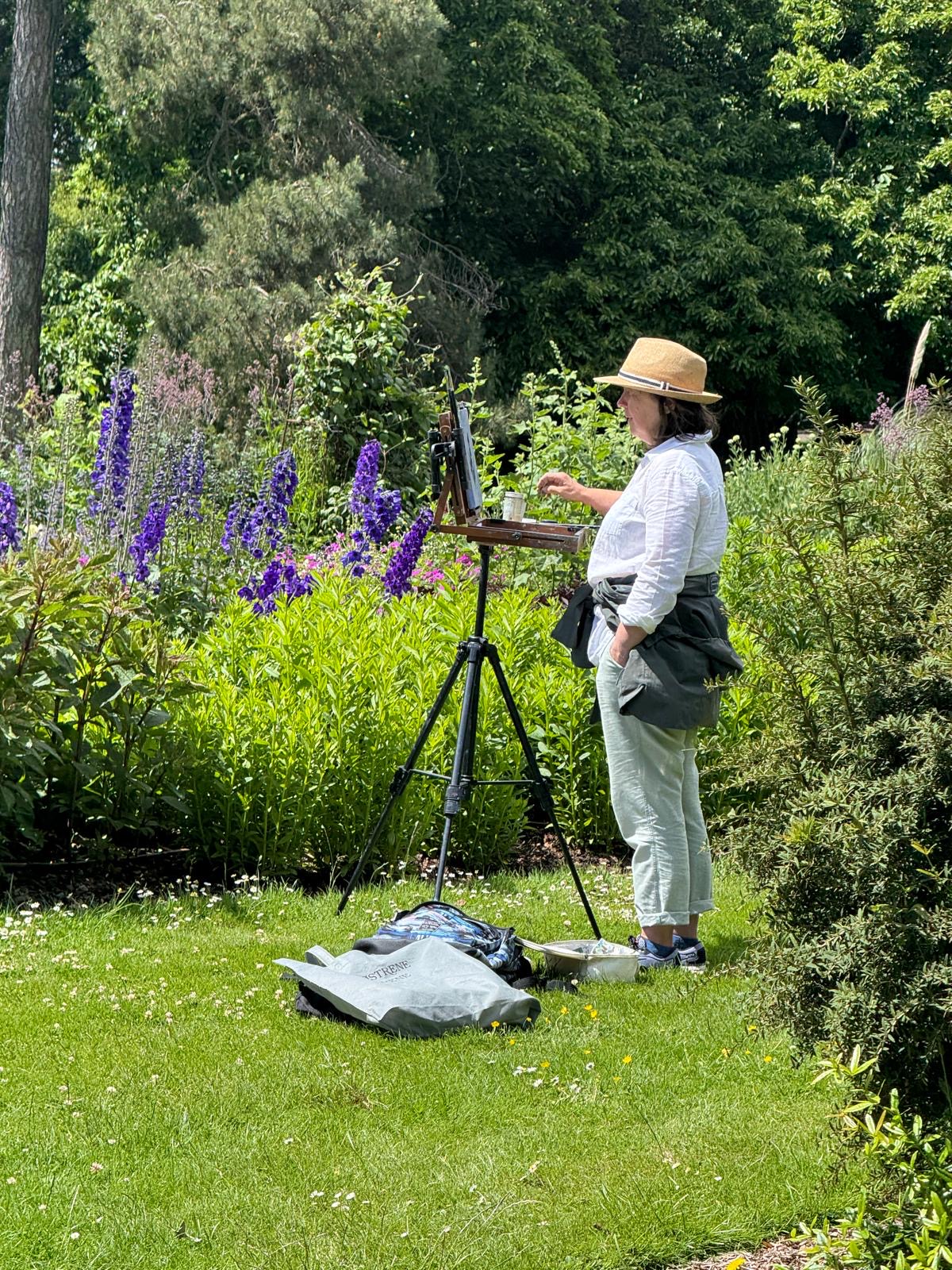 Marie Kelly painting en plein air among the delphiniums at the National Botanic Gardens, Dublin